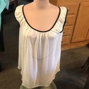 It’s off white with black piping really cute with black top underneath